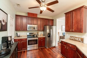 Enjoy cooking and socializing in this well-equipped kitchen with a central island, stove, and ample storage.