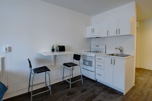 Compact kitchen with oven, sink, and toaster, perfect for preparing meals.