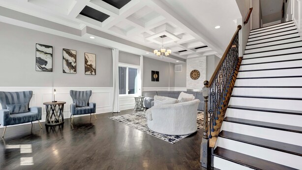 A spacious living room with a staircase, modern furniture, and artwork on the walls. - Lux Home in Chicago 7mins Downtown (Chicago)