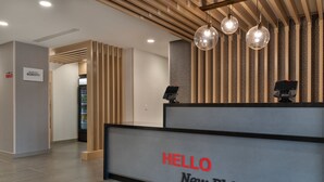 A reception desk with a sign that reads "HELLO New Philadelphia." - Towneplace Suites By Marriott New Philadelphia (New Philadelphia)