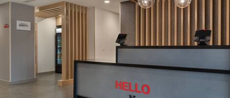 A reception desk with a sign that reads "HELLO New Philadelphia."