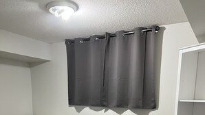 A room with a white dresser, a white cabinet, and a ceiling light fixture. - 5 Mins from Nordic Spa Whitby (Whitby)