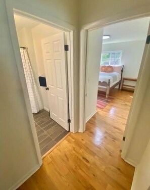 Enter a serene space with a comfortable bed and stylish window treatments.