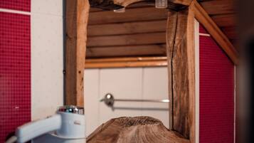 A wooden ceiling structure with a visible light fixture.