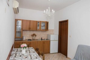 Enjoy meals in this cozy kitchen with a sink, refrigerator, and dining table.
