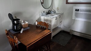 A compact kitchenette with a coffee maker, a sink, and a window with blinds. - Birch Point Resort Kitchenette #14 - Lake Nelson, Hayward (Hayward)