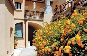 Experience the tranquil courtyard, surrounded by lush greenery and a blend of traditional and modern architecture.