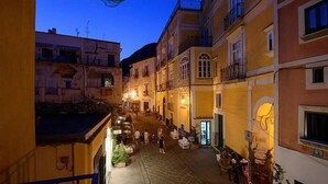 A narrow street with buildings on both sides, some with balconies and others with ground-level entrances. - Modern Apartment close to the Beach - Corso 4 by AMALFIVACATION.IT (MINORI)