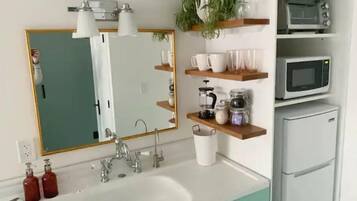 Fridge, microwave, coffee/tea maker, cookware/dishes/utensils