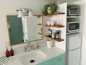 Fridge, microwave, coffee/tea maker, cookware/dishes/utensils