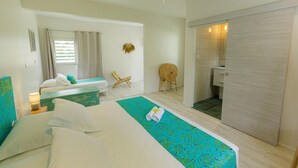 A hotel room with two beds, a bathroom, and a sitting area. - FARE VAVAE (Raiatea)