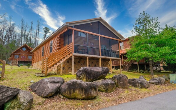 Surrounded by nature, this cabin offers a peaceful retreat with a spacious balcony and large window.