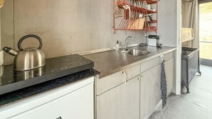 A kitchen with a kettle, sink, and dish rack. - 1 bedroom gorgeous home in Vlissingen (Vlissingen)