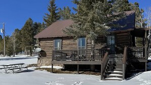 A log cabin with a deck and stairs leading to a porch. - Historic Log Cabin in Greer, AZ.  Located near Molly Butler's & Sunrise Ski Area (Greer)