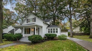 A two-story house with a front porch, a covered entryway, and a small front yard with a pathway. - Historic home in the Village of Lewiston - short walk to dining, concerts, river (Lewiston)