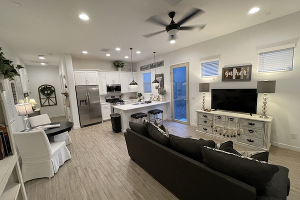 Living area with smart TV, comfy couch that pulls out to a queen sleeper