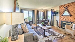 A modern living room with a sofa, coffee table, and a fireplace. - Gorgeous 2BD Condo w Balconies + Pool! Near TOWN! (Gatlinburg)