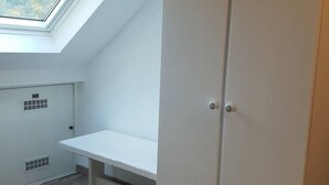 A room with a skylight, a white bench, and a closed door. - T2bis Apartment - Near center - 4/6 people - Mountain view (Cauterets)
