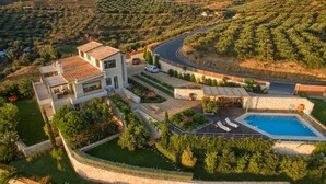 A modern villa with a swimming pool, a curved driveway, and a well-maintained garden. - Luxury Villa Hara with private pool (Malevizi)