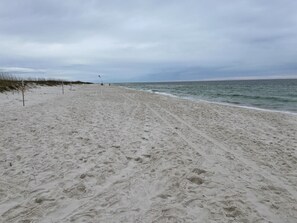 Enjoy a serene beach experience with gentle waves lapping at the shore.