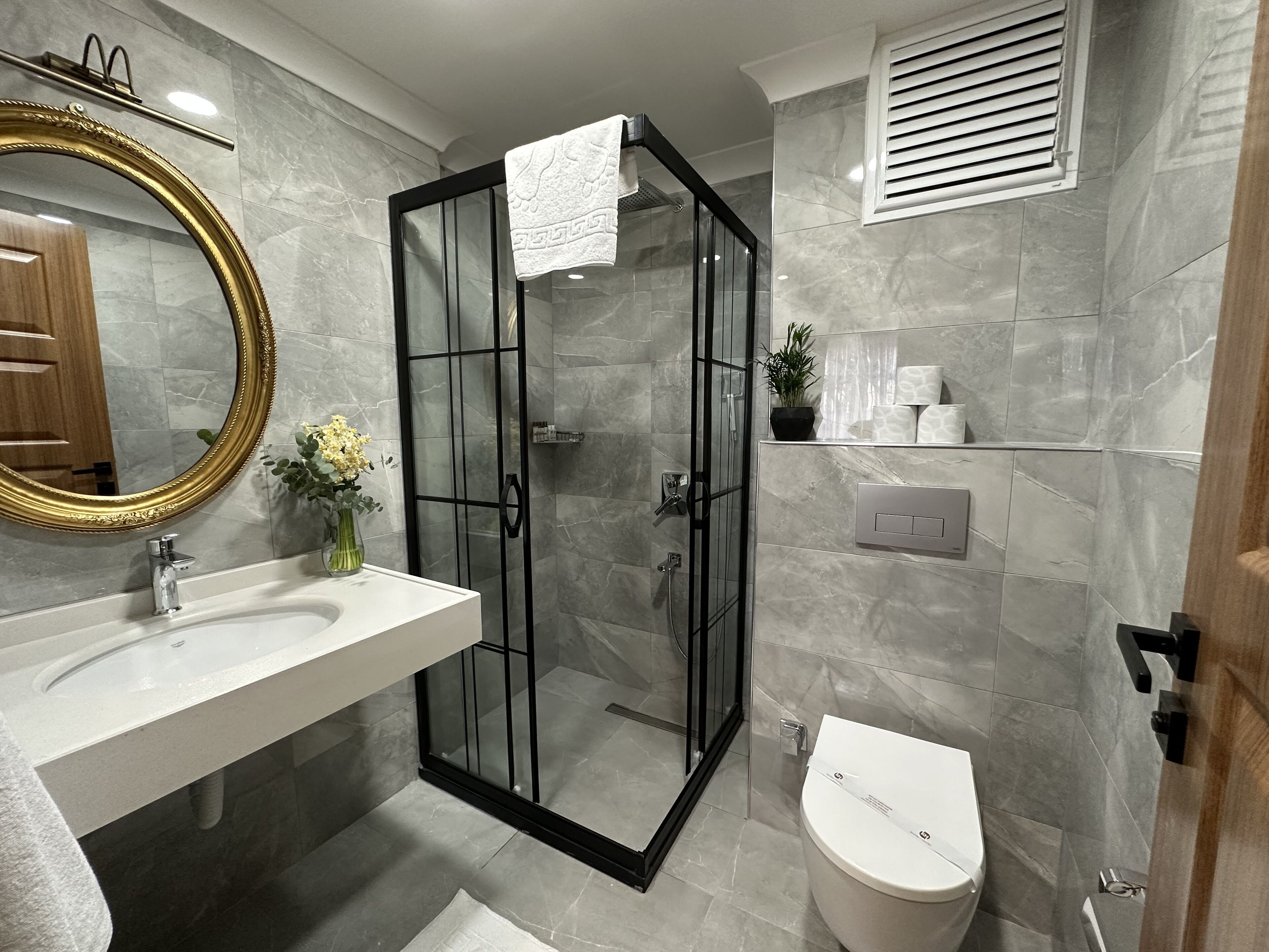 Shower, rainfall showerhead, hair dryer, towels