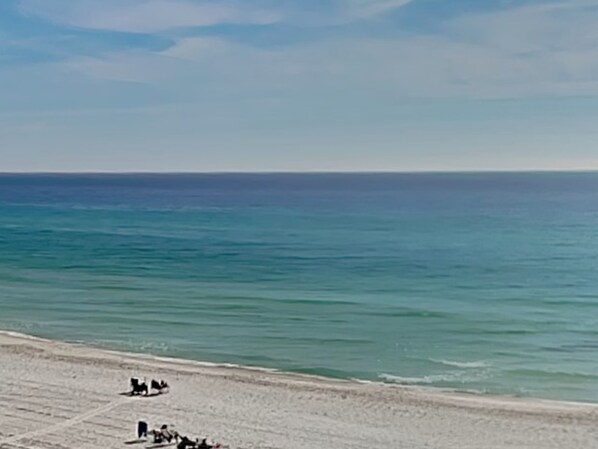 A beach with a clear sky and calm sea.