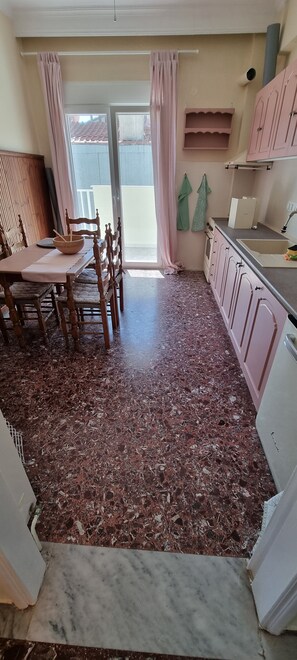 Enjoy meals at the dining table for four, with a convenient balcony access.
