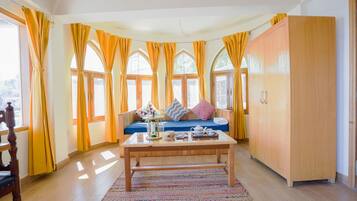 Deluxe Double Room | Living area | 36-inch LED TV with satellite channels, TV