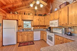 Enjoy cooking in this well-equipped kitchen with a refrigerator, dishwasher, microwave, stove, and coffee maker.