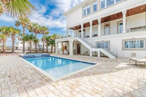 A two-story building with a pool, outdoor seating, and a staircase leading to the upper level. - Gulf View Estate,Private Pool & Hot Tub (Navarre)