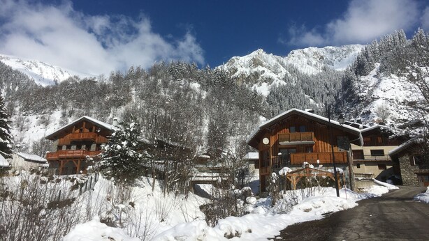 A snow-covered mountain village with wooden cabins and a clear blue sky. - THE THREE SNAP HOOKS (Champagny-en-Vanoise)