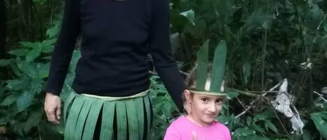 Two people in costumes in a forested area.