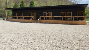 Un bâtiment moderne doté d’une terrasse en bois et de nombreuses fenêtres.