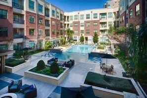 Experience the beauty of open spaces at this contemporary building, featuring a central courtyard with a swimming pool and outdoor seating areas.