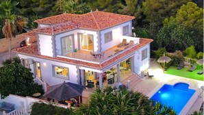A two-story house with a red-tiled roof, large windows, and a swimming pool. - High Quality Villa, 39 Five STAR REVIEWS, Beach 5 min drive, Heated Pool. (Calpe)