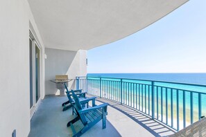 Enjoy ocean views from this balcony with a grill and two comfortable chairs.