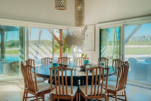 Enjoy meals in this dining area with a round table and six comfortable chairs, surrounded by a beautiful view of the landscape.