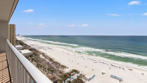 A beach view from a balcony with a clear sky, sandy beach, and ocean waves. - The Summit PCB 1504 ** Large Updated Condo with Huge Beachfront Balcony (Panama City Beach)