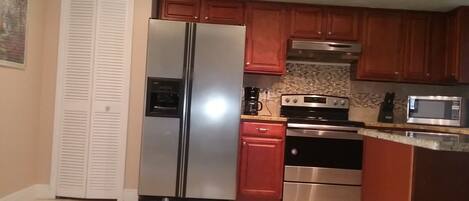 Fridge, stovetop, dishwasher, coffee/tea maker