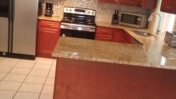 Fridge, stovetop, dishwasher, coffee/tea maker