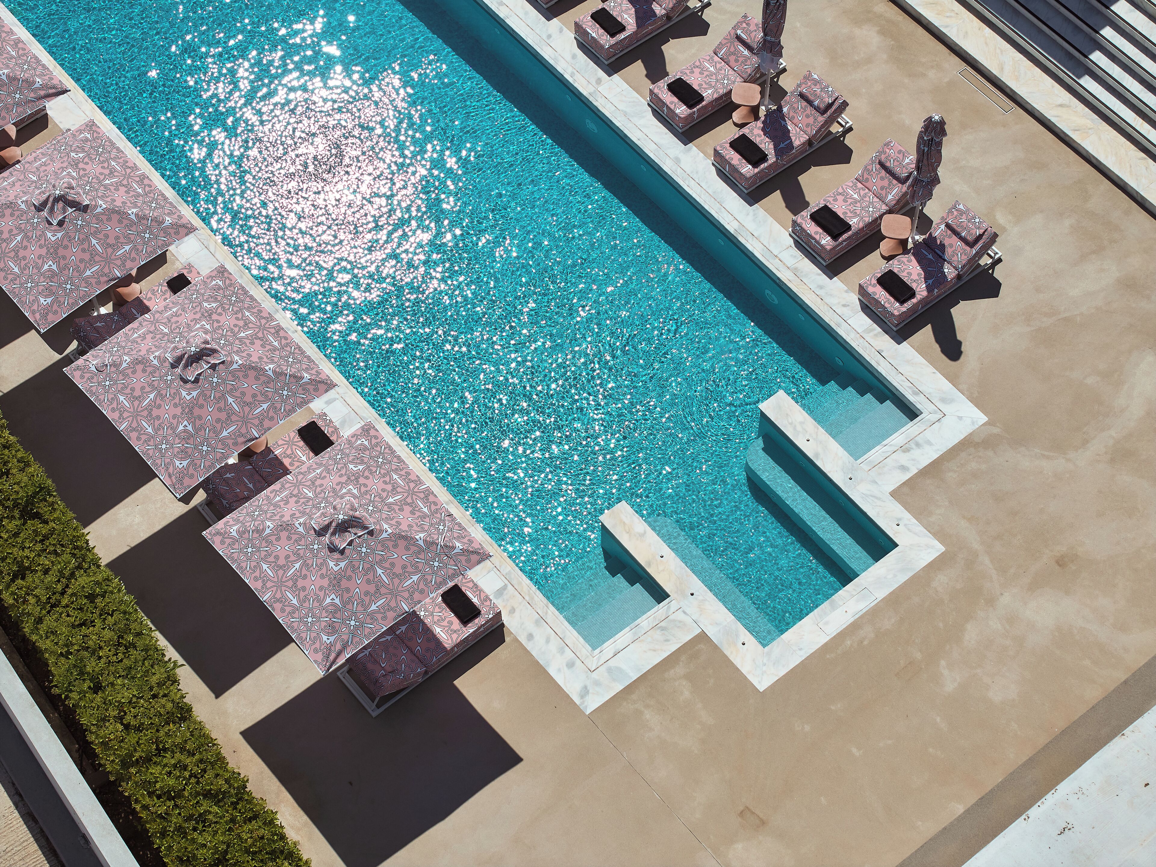 Seasonal outdoor pool, open 9:00 AM to 8:00 PM, pool umbrellas