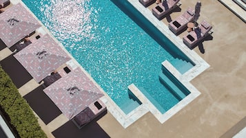 Seasonal outdoor pool, open 9:00 AM to 8:00 PM, pool umbrellas