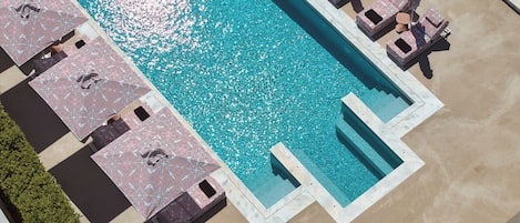 Seasonal outdoor pool, open 9:00 AM to 8:00 PM, pool umbrellas