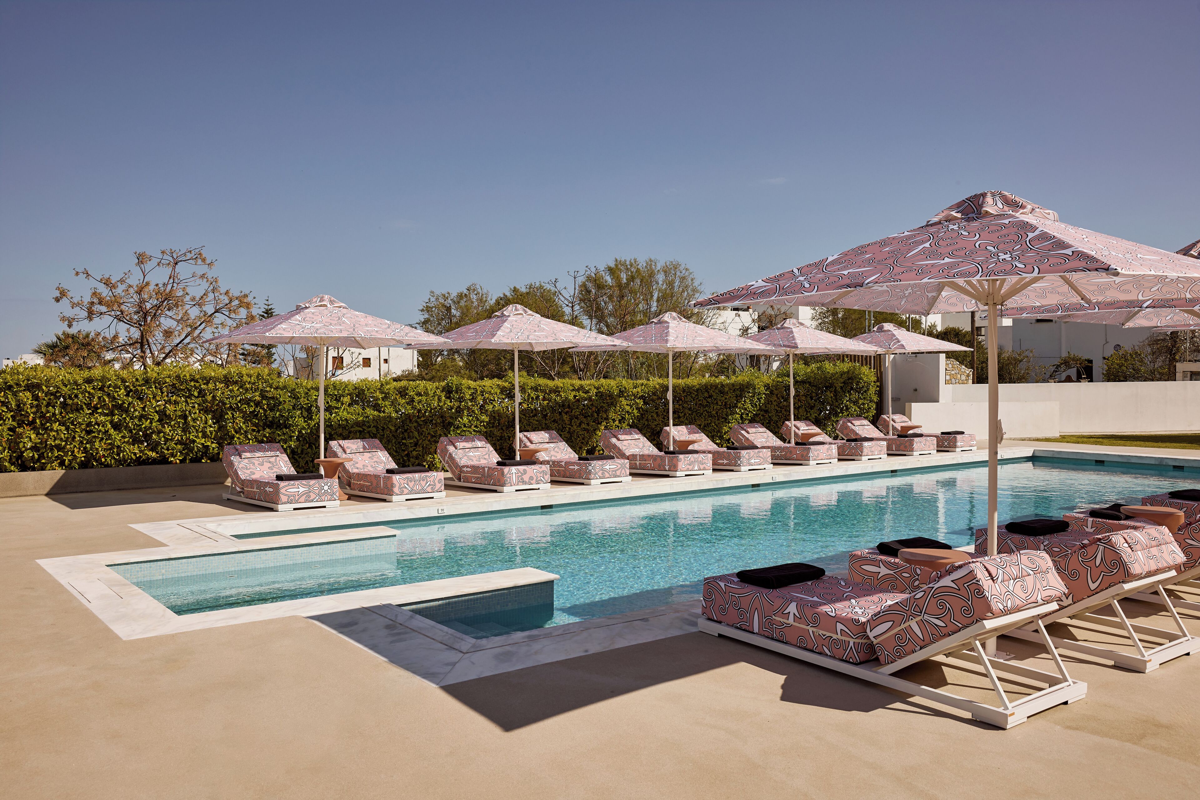 Una piscina al aire libre de temporada, sombrillas