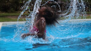A person in a swimming pool with water splashing around them. - Sunshine Inn (Luganville)