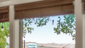 A view from a window with a metal railing, a blue bridge, and hills in the background. - Riverview Home - walking trails - convenient location (Clarkston)