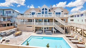 A multi-story house with a swimming pool, outdoor seating, and a deck. - LUXURY, OCEANFRONT, Pool, ELEV, Rec Rm, Beach Access, Ocean Views! WL983, Fairlight (Corolla)