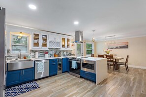 Enjoy meals in the kitchen with an oven, stovetop, and dishwasher, and dine at the wooden table.