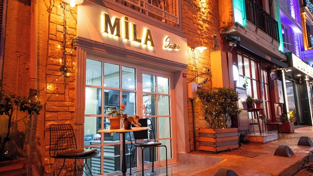 A building with a sign reading 'MILA Suites' and outdoor seating with chairs and tables. - Mila Suites Taksim (Istanbul)