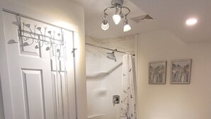 A bathroom with a toilet, shower, and sink. - Cozy Home Away from Home (Kingston)